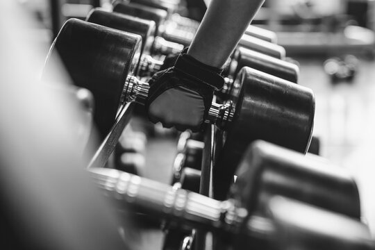 Black and white images Hand holding dumbbell in the gym bodybuilding