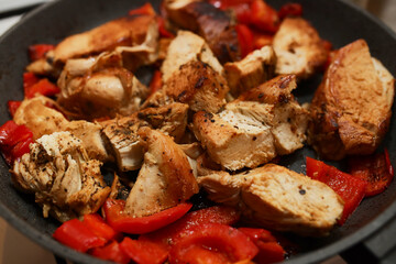Juicy fried chicken fillet with bell pepper.
