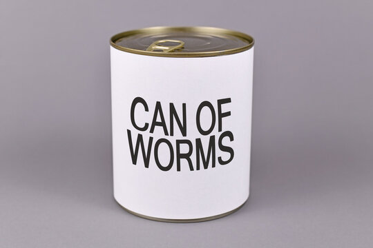Concept for dfifficult situations and unpleasant experiences showing a tin can with white label and words 'Can of worms' on gray background