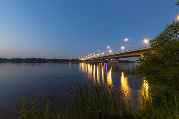 Fototapeta na wymiar Beautiful evening landscape with a transport bridge and a river