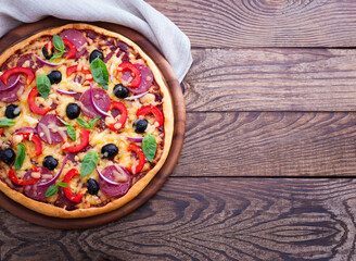 Delicious pizza served on wooden table top view