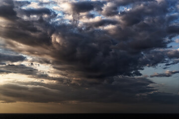 Naklejka na ściany i meble Beautiful cumulus cloud above sea during sunset
