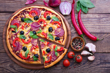 Delicious pizza served on wooden table top view