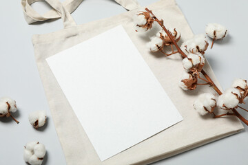 Cotton,bag and empty sheet on light gray background, space for text