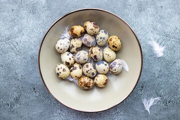 Quail eggs inside a decorative plate and on a background