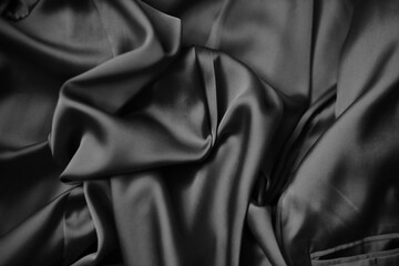The fabric is silk. Silk drapery. The silk is beige. The cloth.black and white image.
