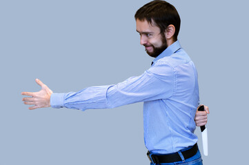 The concept of betrayal business. businessman holds out his hand for a handshake and holds a knife...