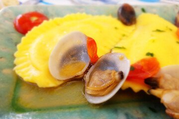 Italian Pasta, ravioli, with clams. Seasoned with olive oil, parsley and tomato