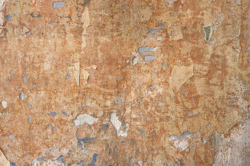 old vintage wall with an interesting abstract texture and orange  background irregular color - broken wallpaper 