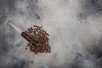 Coffee beans with a wooden spoon and cinnamon sticks