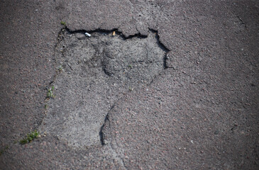 Obraz premium Broken asphalt and cracks on the road surface