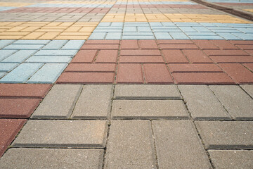 Stone pavement in perspective. Stone pavement texture. Granite cobblestoned pavement background. Multicolored brick stone background