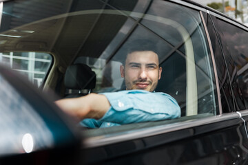 Successful stylish man outside the car window