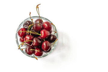 juicy sweet cherries in a glass bowl isolated on white