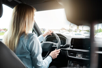 Business woman driving a modern car