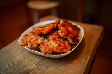  Homemade chicken cutlets. The plate is full of delicious chicken meatballs prepared for food. Fried chicken cutlets. Grilled chicken breast on a white dish on an old rustic wooden background.