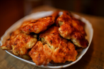  Homemade chicken cutlets. The plate is full of delicious chicken meatballs prepared for food. Fried chicken cutlets. Grilled chicken breast on a white dish on an old rustic wooden background.