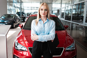 Portrait of a business woman on a background of a car