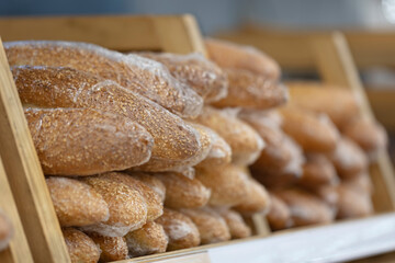Baguettes with sesame are lying on supermarket shelf