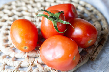 .Fresh Italian tomato on straw mat with blurred © Augusto B.  Clicks