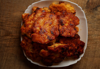 Homemade chicken cutlets. The plate is full of delicious chicken meatballs prepared for food. Fried chicken cutlets. Grilled chicken breast on a white dish on an old wooden background.