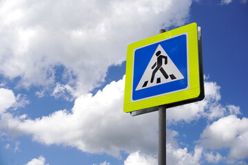 Road sign pedestrian. Pedestrian transit traffic sign  on sky background, the concept of road safety