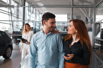 Happy couple at car dealership