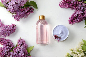 Obraz na płótnie Canvas Spa ingredients with fragrant pink water from lilac flowers and body cream and skin and body care, aromatherapy, lifestyle concept, greeting card for presentation and invitation