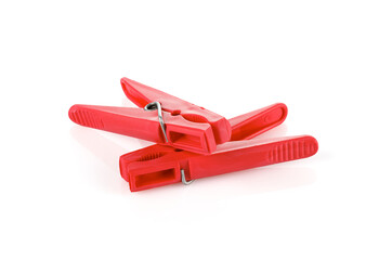 Red plastic clothespins isolated on white background. Plastic clips. Close-up. Full depth of field.