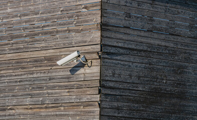 Video Surveillance Home Property Camera Side View on Wooden Wall Outdoor Technology Secure Concept