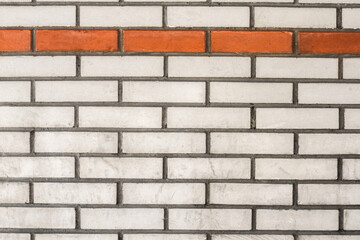 Old white brick wall with orange line