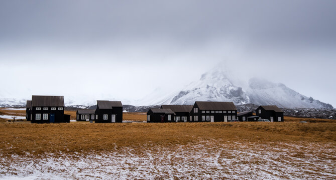 Cabin houses and the snowcapped stapafel mountain Hellnar, Snaefellnes peninsula Iceland