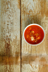 Dish with thai tom yam soup on a wooden table. Vertical