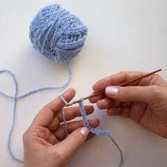 The process of crocheting close-up. Learning to knit. Woman knits.