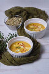 Pumpkin cream soup with thyme and cream.
