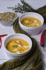 Pumpkin cream soup with thyme and cream.
