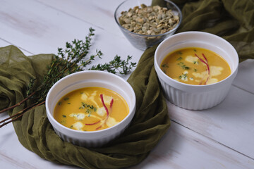 Pumpkin cream soup with thyme and cream.