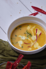 Pumpkin cream soup with thyme and cream.