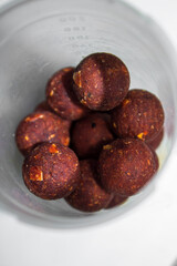 brown fishing boilies in a transparent jar