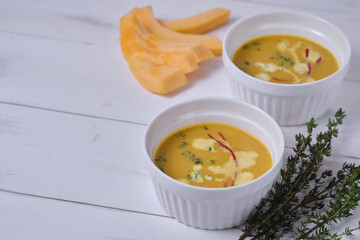 Pumpkin cream soup with thyme and cream.