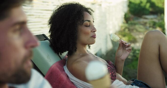 MS R/F Couple relaxing on sun loungers and eating ice creams / Claremont, Cape Town, South Africa