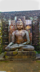 Buddha statue in granite rock at udayagiri hill , Odisha,india. Buddha in meditation position,sky on head
