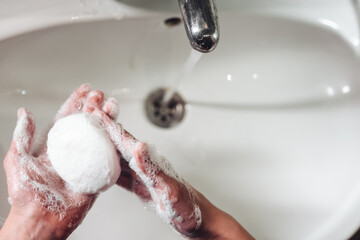 Fototapeta premium Man washing hands to protect against the coronavirus