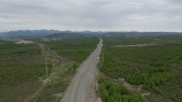 Flight on a drone over the Kolyma highway connecting the villages of Palatka and Stekolniy. The Far East of Russia.
