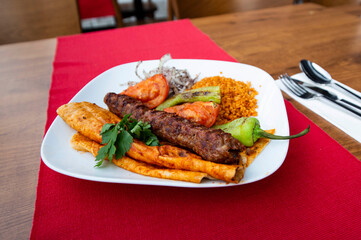 Turkish Adana Kebap With bulgur pilaf And Vegetables Served On A Plate