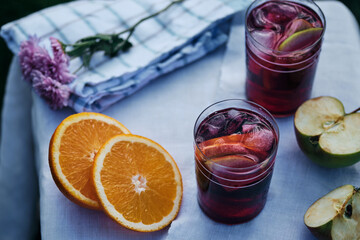 Spanish alcoholic cocktail of wine and fruits. Sangria in glasses with ice and slices of fruit.