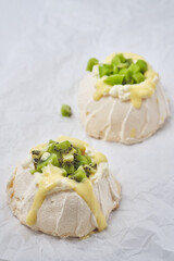 Pavlova cake with cheese cream, lemon Kurd, kiwi and pear.