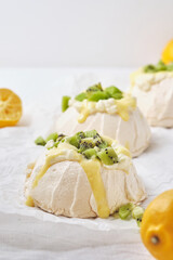 Pavlova cake with cheese cream, lemon Kurd, kiwi and pear.