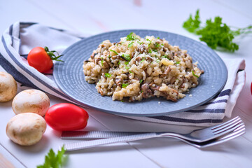 Mushroom risotto garnished with fresh parsley and grated parmesan.