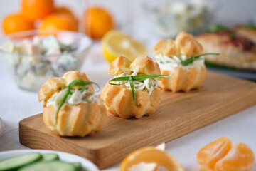 Profiteroles with soft cheese, red fish and herbs. Gourmet meal on the holiday table.